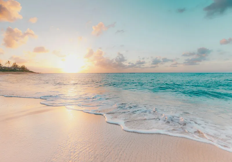 Golden sunset over a calm sandy beach