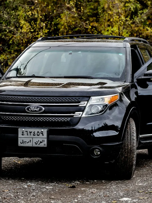 A black SUV with its doors open, ready for passengers