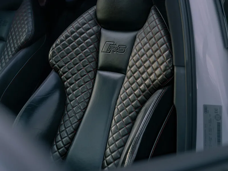 Close-up of a quilted black leather car seat